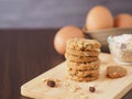 Stack healthy homemade oat cookies on wooden boards with egg.