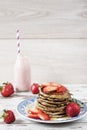 Stack of healthy low carbs oat and banana pancakes over white wooden background