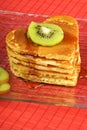 Stack of heart-shaped pancakes with syrup and kiwi fruit Royalty Free Stock Photo