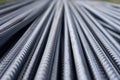 Stack of heavy metal reinforcement bars with periodic profile texture. Close up steel construction armature. Abstract industrial b