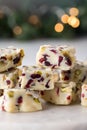 A stack of homemade cranberry and pistachio white chocolate fudge.