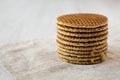 Stack of homemade Dutch stroopwafels with honey-caramel filling on cloth, side view. Copy space