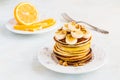 Stack of homemade pancakes with banana, maple syrup and walnuts on vintage plate. Royalty Free Stock Photo