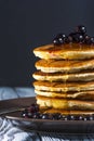 Stack of homemade pancakes with berries and honey on brown plate on rustic background. Royalty Free Stock Photo