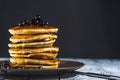 Stack of homemade pancakes with berries and honey on brown plate on rustic background. Royalty Free Stock Photo