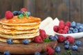 Stack of homemade pancakes with fresh blueberries, raspberries and maple syrup. Royalty Free Stock Photo