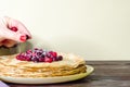 Stack of homemade thin pancakes with cranberries,stack of homemade thin pancakes with cranberries,