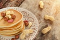 Stack of hot pancakes with nuts on the plate