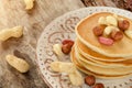 Stack of hot pancakes with nuts on the plate
