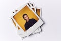 Stack Of Instant Film Photos From Modeling Casting In Studio With Shot Of Young Man On Top