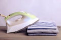 Stack of ironed sweatshirts and an iron