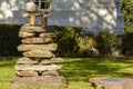 Stack of irregular shaped stones with a pi number figure on top.