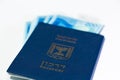 Stack of israeli money bills of 200 shekel and israeli passport Royalty Free Stock Photo