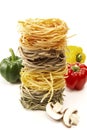 Stack of italian pasta, tagliatelle, mushroom slices and bell peppers Royalty Free Stock Photo