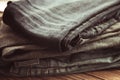 Stack of jeans on wooden background, toning vintage image