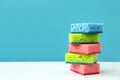 Stack of kitchen cleaning sponges on blue background. Front view Royalty Free Stock Photo