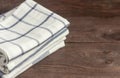 A stack of kitchen towels are stacked on an old rustic table Royalty Free Stock Photo