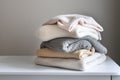 Stack of knitted clothes on table, woolen laundry, winter clothes, pile of knitwear Royalty Free Stock Photo