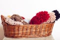 Stack of knitted hats and yarns in a basket Royalty Free Stock Photo