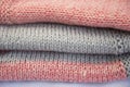 A stack of knitted items. Pink jersey with gray stripes. Knitted fabric Royalty Free Stock Photo