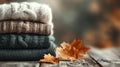 Stack of Knitted Sweaters with Autumn Leaves Royalty Free Stock Photo