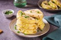 A stack of Kystyby - thin flatbread filled with mashed potatoes and onions on a plate