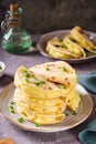 A stack of Kystyby - thin flatbread filled with mashed potatoes and onions on a plate. Vertical view Royalty Free Stock Photo