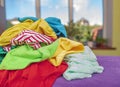 Stack of laundry for ironing on an ironing board. Royalty Free Stock Photo