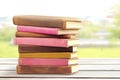 Stack of Leather Journals on Wooden Table A stack of leatherbound journals sits on a wooden table symbolizing knowledge Royalty Free Stock Photo