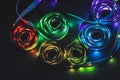 A stack of LED lights on coiled flexible lighting strips, various colors