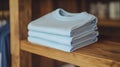Stack of Light Blue T-shirts on Wooden Shelf Royalty Free Stock Photo