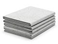 Stack of light gray folded fabrics with textured patterns isolated on white background Royalty Free Stock Photo