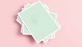 Stack of Light Green A4 Paper Sheets on a Soft Pink Background Layout Royalty Free Stock Photo