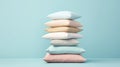 A stack of light soft pillows for a comfortable and sound sleep on a light background with copy space