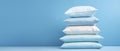 A stack of light soft pillows for a comfortable and sound sleep on a light background with copy space