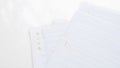 Stack of Lined Notebook Paper Sheets on White Surface for Writing and Notes Royalty Free Stock Photo