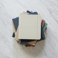 A stack of lined notebooks with plain covers in various muted colors including beige, Royalty Free Stock Photo