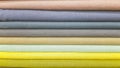 A stack of linen in gray and yellow shades