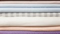 A stack of linen in white and pink shades