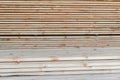 Stack of lumber of a wooden board from a tree, close-up, background. Wooden boards at the sawmill, carpentry workshop Royalty Free Stock Photo