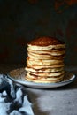 A stack of lush punkcakes for breakfast on a gray background. High pile of delicious pancakes with berries.