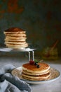 A stack of lush punkcakes for breakfast on a gray background. High pile of delicious pancakes with berries.