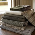 Stack of Luxurious Textured Throws in Earthy Tones A closeup image showcasing a variety of fabrics and textures perfect for home Royalty Free Stock Photo