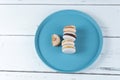 Stack of macarons with dulce de leche filling and chocolate ganache next to a macaron with a bite