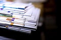 Stack of magazines and annual reports on dark background. Isolated Selective focus. Royalty Free Stock Photo