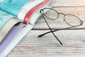 Stack magazines with glasses on wooden table