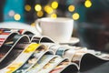 Stack Magazines place or Old books on black desk with coffee cup background. selective focus