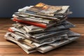 A stack of magazines sitting on top of a wooden table Royalty Free Stock Photo