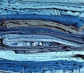 Stack of many colorful folded jeans close-up Royalty Free Stock Photo