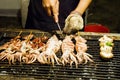 Stack of many grilled squid skewers on the grill in the Taiwan night market.